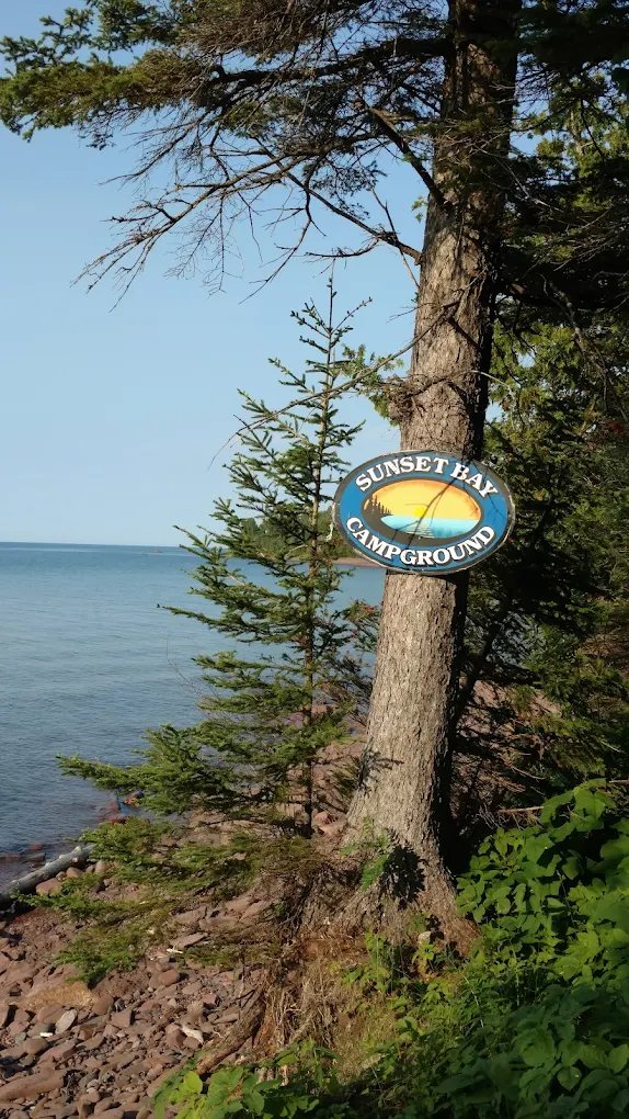 The Sunset Bay sign on a pine overlooking Lake Superior